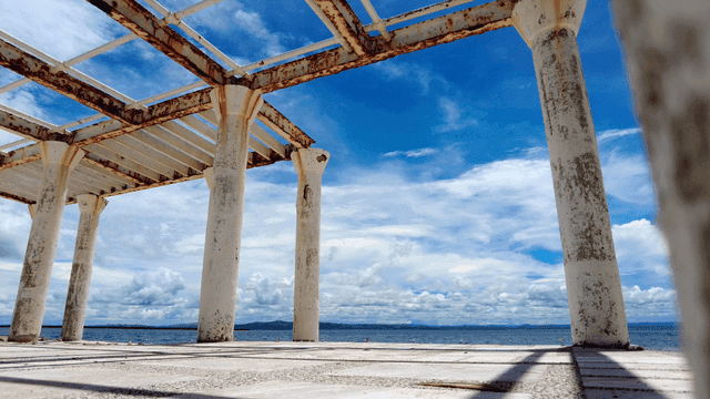 Old structure by the sea under a blue sky