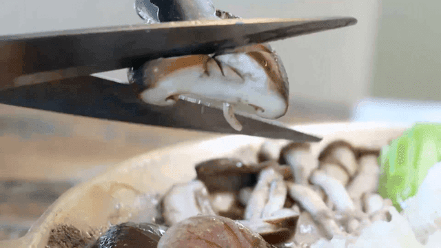 Mushrooms being sliced with scissors