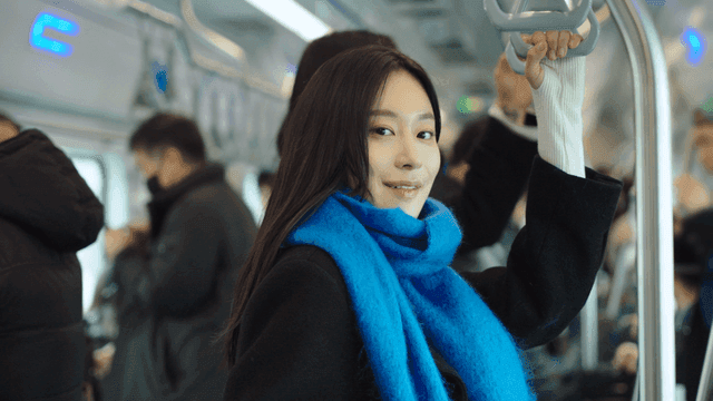 Woman in a blue scarf on a subway