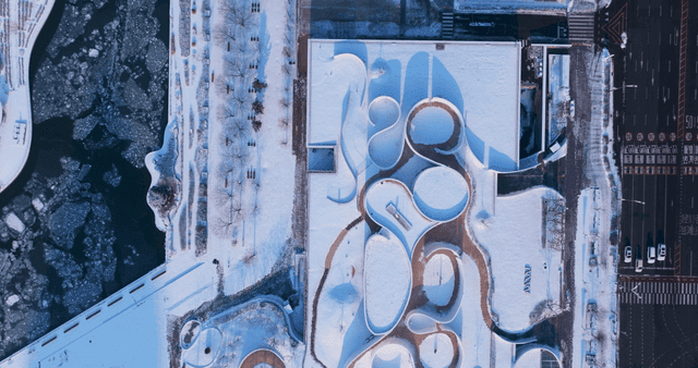 Snow-covered park with winding walking paths