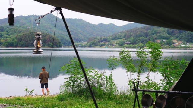 Early morning fishing by the lake in a scenic campsite