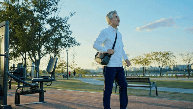 Elderly man walking in park