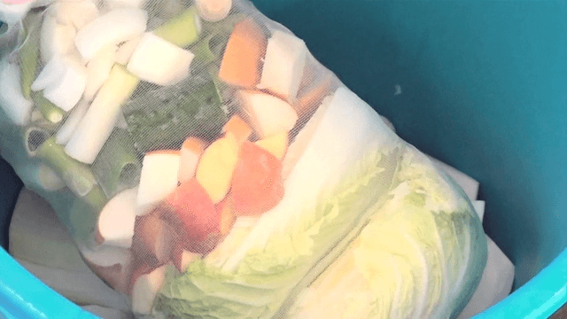 Radish pieces and vegetable pouch in a stock pot