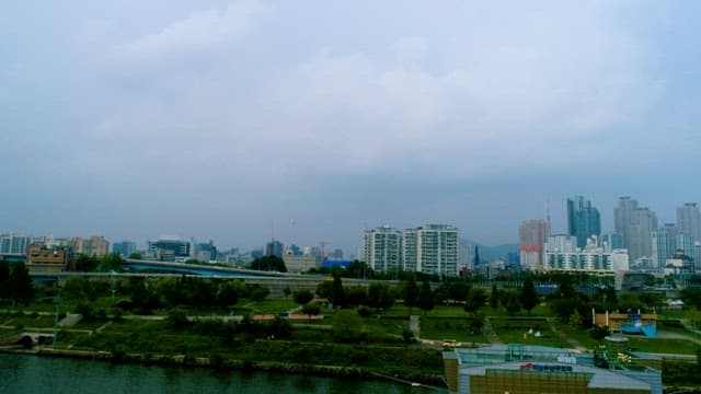 Overcast Skyline and River in a Busy City