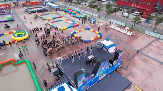 People enjoying the local festival and dancers performing on stage