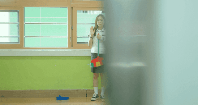 Schoolgirl practicing a greeting alone