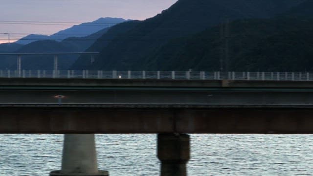 Bridge over a river with mountains