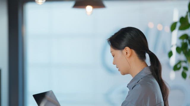 Woman working on a laptop in an office