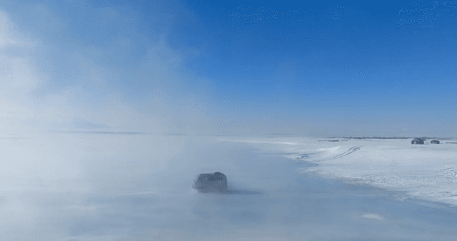 Van driving on a snowy landscape