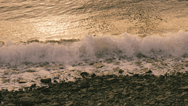 Waves gently crashing on a rocky shore