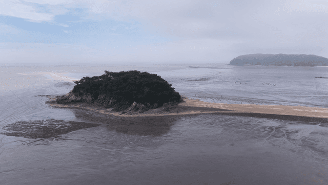 Small island connected by sandbar