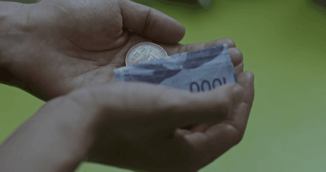 Hands holding coins and banknotes