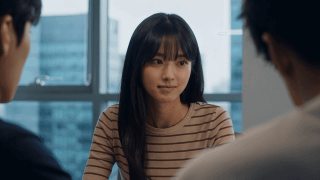Woman communicating with colleagues in conference room