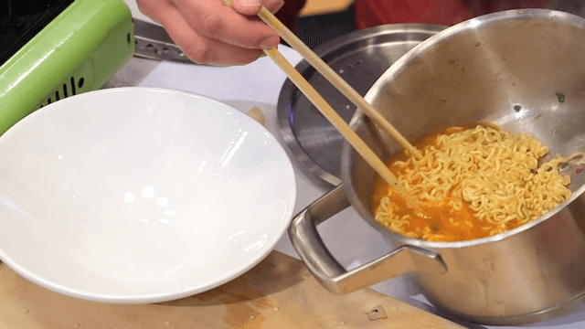 Putting ramyeon with eggs in a bowl