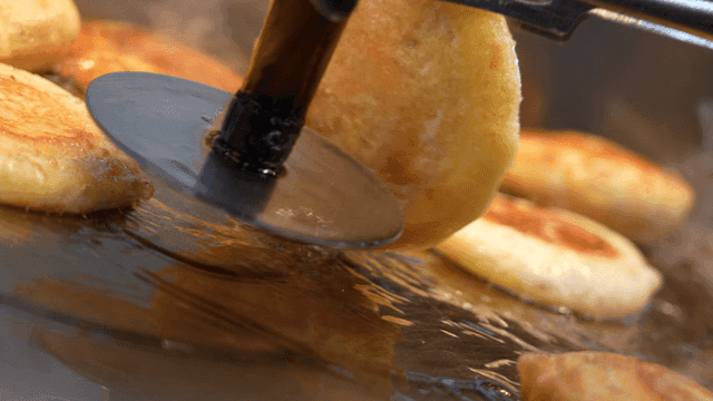 Hotteok fried on hot iron plate