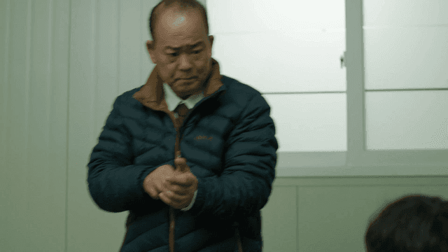 Man standing up while taking off his watch