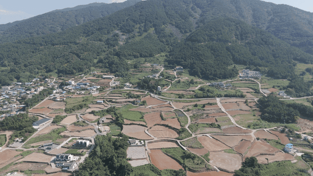 Rural village surrounded by green mountains