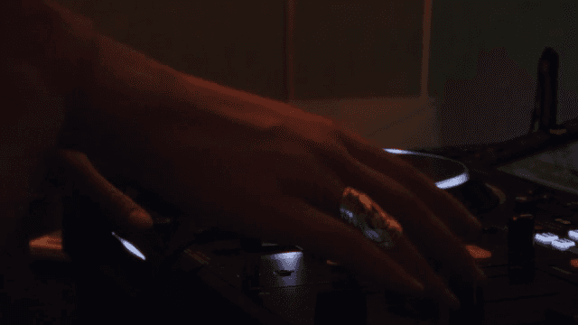 DJ mixing music in a dark space