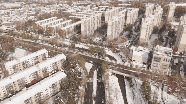 Snow-covered cityscape with apartments