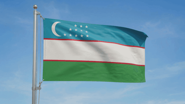 Uzbekistan flag waving in the clear sky