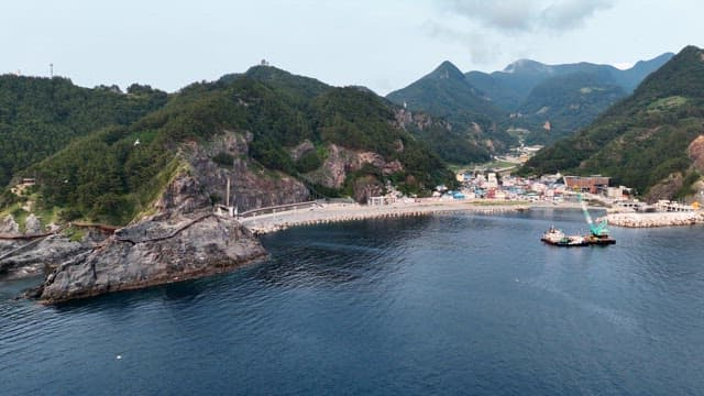 Coastal village with mountains and sea