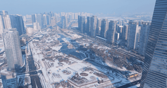 Snow-covered cityscape with tall buildings