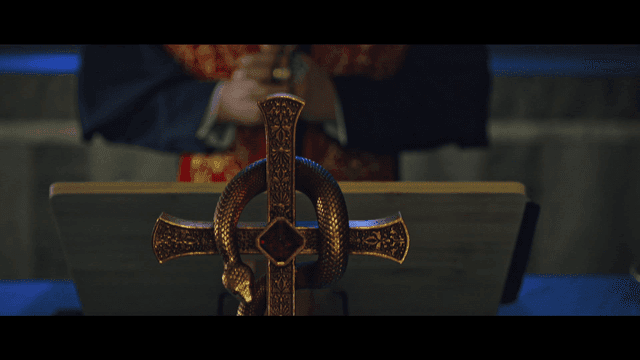 Catholic cross with snake and bishop