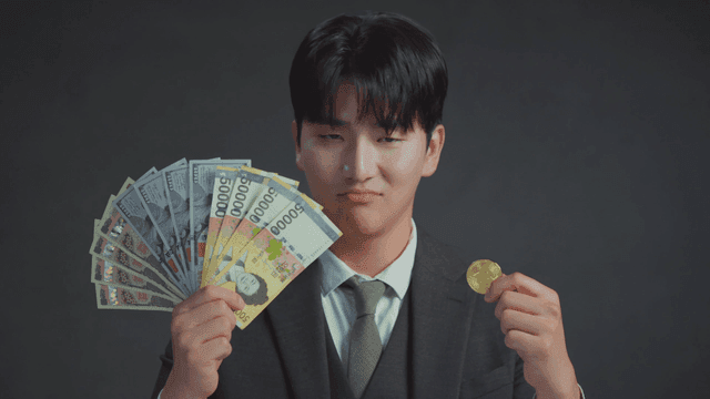 Man smiling at the Bitcoin in his hand