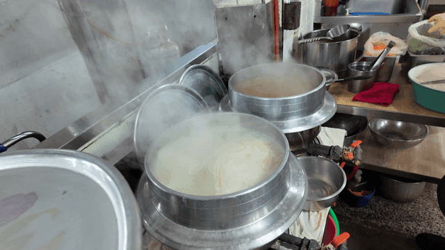 Steaming pots in a busy kitchen