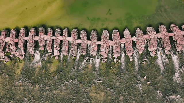 Aerial view of stepping stones over a clear river