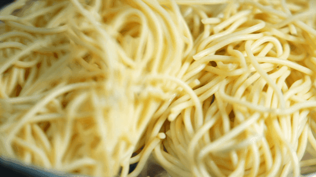 Octopus and noodles being cooked together