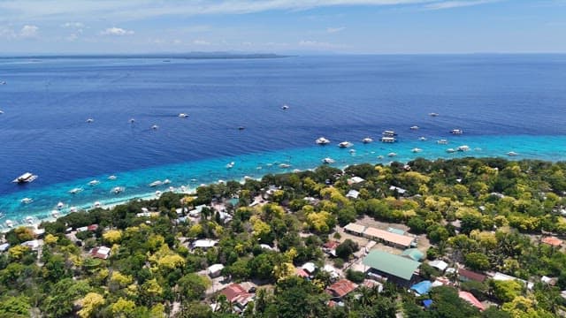 Coastal village with boats and clear sea