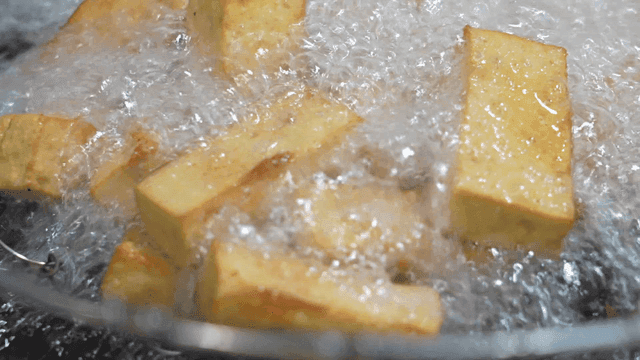 Tofu frying in hot oil