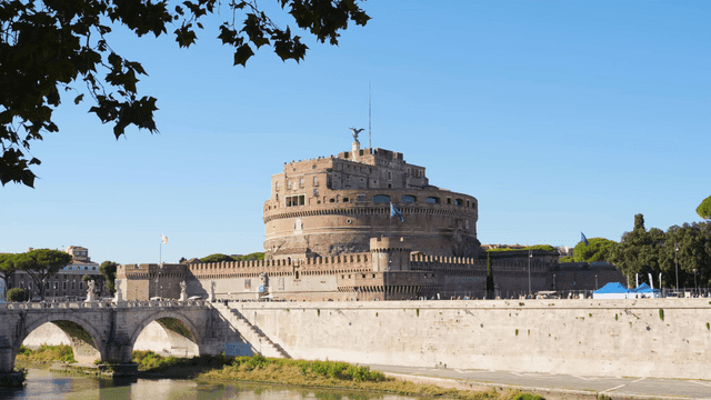 Historic castle by the river under clear sky