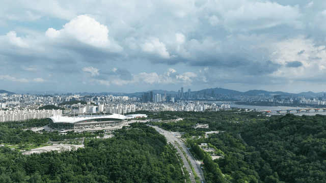 Vast city landscape with stadiums and greenery
