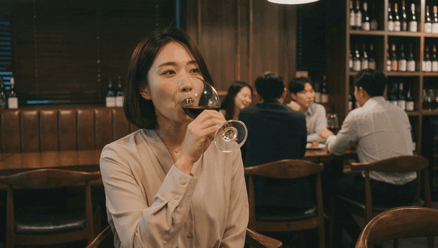 Woman drinking wine in cozy restaurant