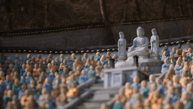 Buddha statues surrounded by monk statues