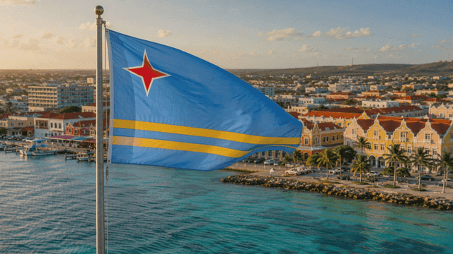 Aruba flags waving by water and colorful buildings