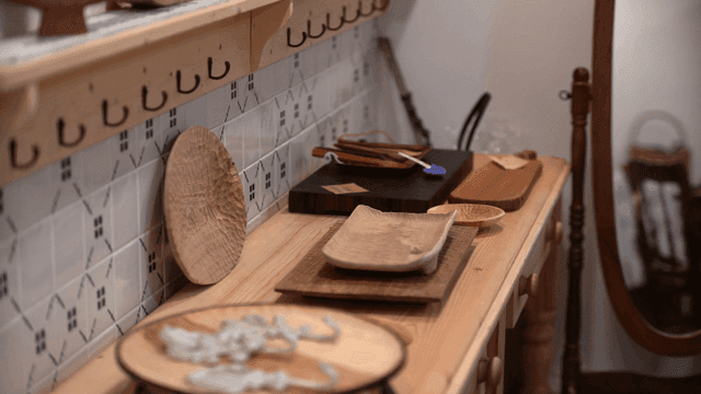 따뜻한 조명 아래 나무 식기들이 놓인 작업대