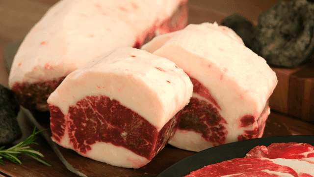Thick marbled beef chadolbagi on cutting board