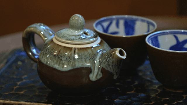 Ceramic teapot and cups on a tray
