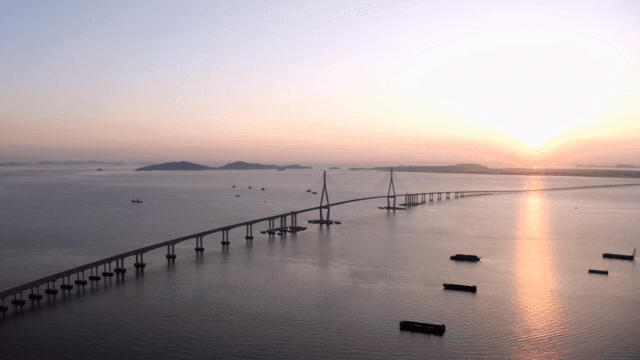 Long bridge over the sea at sunset