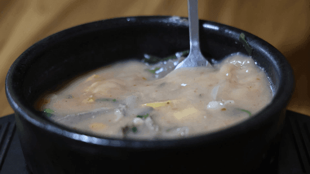 Beef soup stirred with spoon