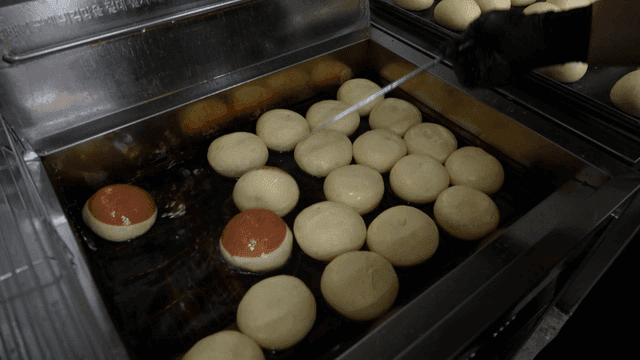 Frying bread dough balls in hot oil