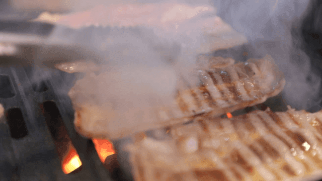 Thin slices of pork belly grilled on barbecue grill