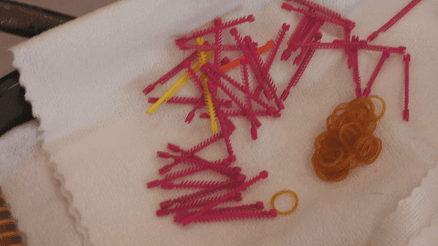 Colorful hair perm tools on white towel
