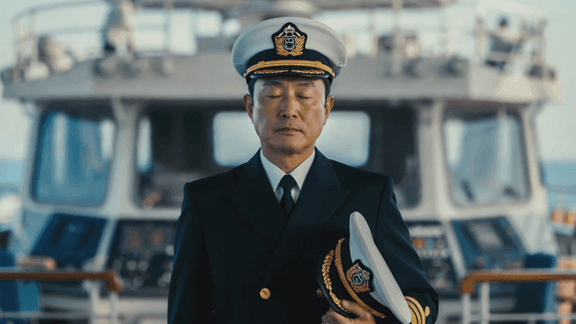 Navy captain standing on deck