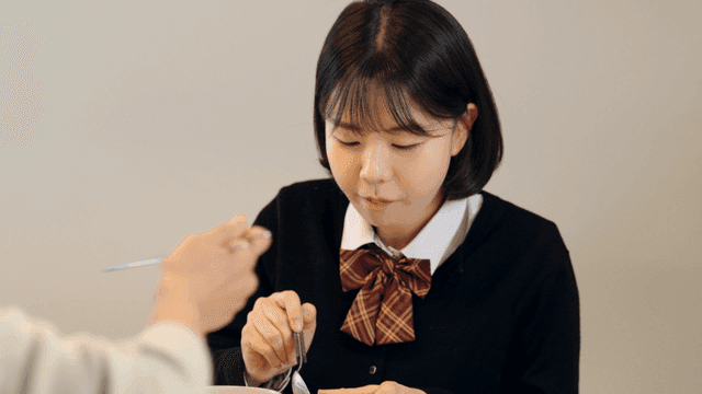 High school girl eating at home