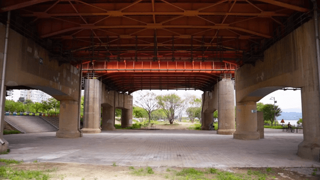Under a bridge with a view of trees