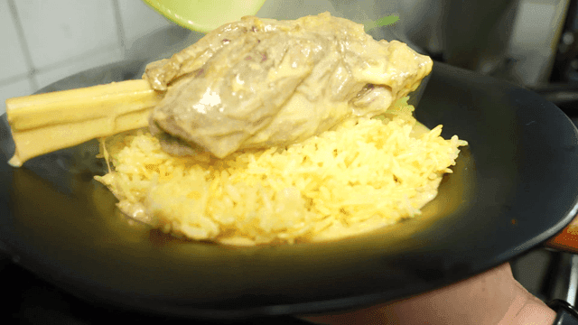 Lamb Mansaf served over bowl full of rice